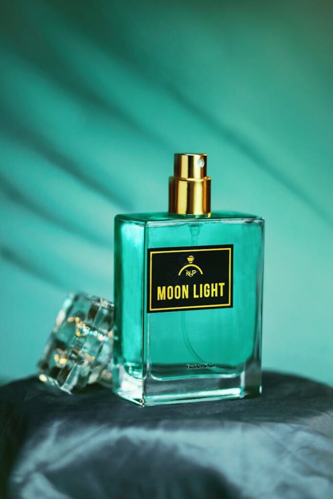 Artistic capture of a Moon Light perfume bottle with moody lighting and soft blue tones.