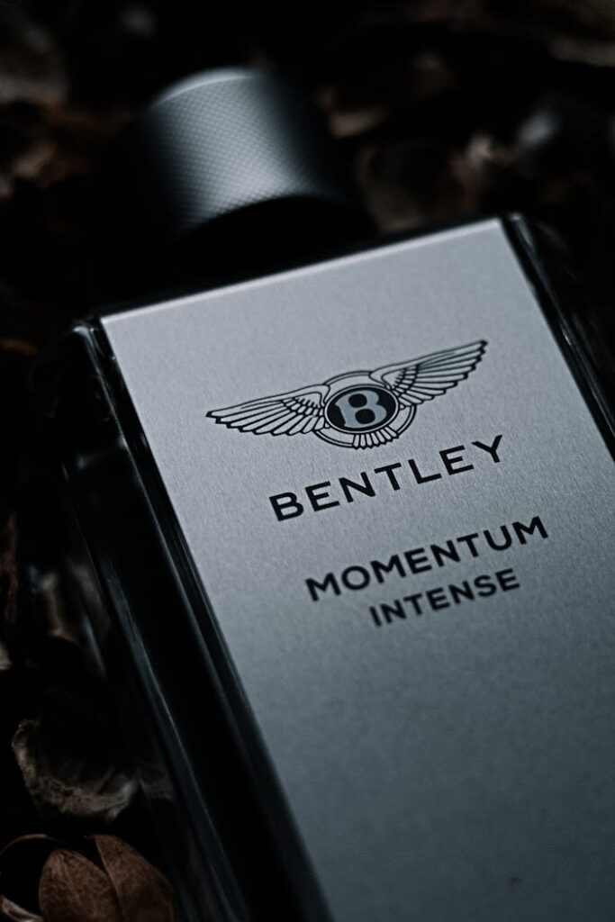 Close-up of Bentley Momentum Intense perfume bottle showcasing luxury design.